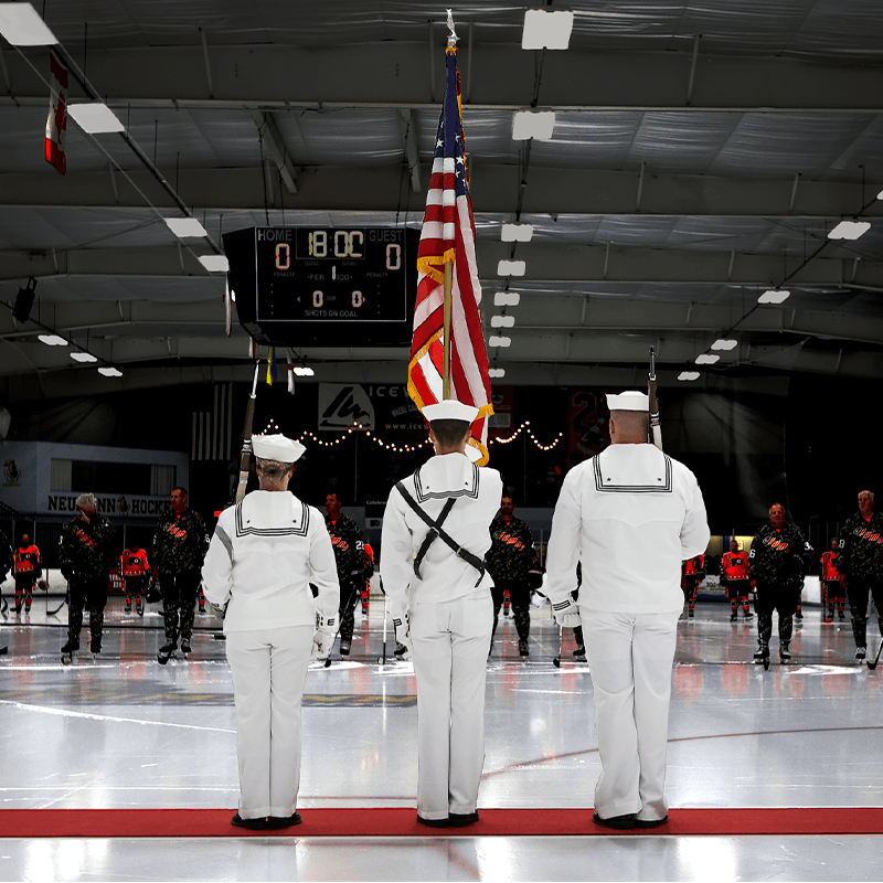 US Navy Sailors holding US Flag